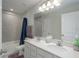 Bathroom features double sinks, a large mirror, and tile flooring at 10803 High Noon Trl, Parrish, FL 34219