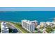 Aerial view of condos along the coast with beach access and vibrant blue waters at 11 Sunset Dr # 303, Sarasota, FL 34236