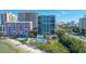Aerial view of community pool, building, beach access, and easy access to roads at 11 Sunset Dr # 303, Sarasota, FL 34236