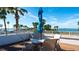 Outdoor dining on the terrace, offering stunning ocean views and a shady umbrella at 11 Sunset Dr # 303, Sarasota, FL 34236