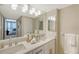 Bright bathroom offers double sinks, marble countertops and shaker cabinets at 11 Sunset Dr # 303, Sarasota, FL 34236