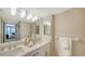 Bright bathroom features double sinks with modern fixtures and a view into the bedroom at 11 Sunset Dr # 303, Sarasota, FL 34236