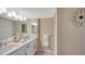 Bathroom featuring a double vanity with quartz countertops, modern lighting, and large mirror for enhanced functionality at 11 Sunset Dr # 303, Sarasota, FL 34236