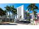 Exterior shot of the 'Sunset Towers' condo building featuring lush landscaping at 11 Sunset Dr # 303, Sarasota, FL 34236