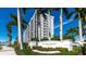Exterior shot of the Sunset Towers building, showcasing its modern design and lush landscaping at 11 Sunset Dr # 303, Sarasota, FL 34236