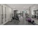 Fully-equipped gym with machines, free weights, and floor-to-ceiling windows overlooking the cityscape at 11 Sunset Dr # 303, Sarasota, FL 34236
