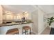 Kitchen featuring bar-top seating, sleek stainless steel appliances, and custom cabinets at 11 Sunset Dr # 303, Sarasota, FL 34236