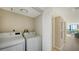 Laundry room including washer and dryer located off the hallway at 11 Sunset Dr # 303, Sarasota, FL 34236
