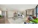 Open-concept living room showcasing sleek floors, modern furniture, and access to a balcony at 11 Sunset Dr # 303, Sarasota, FL 34236