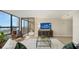 Spacious living room with contemporary design, a balcony, and a large TV at 11 Sunset Dr # 303, Sarasota, FL 34236