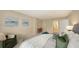 Bright main bedroom with a comfortable upholstered bed, stylish chair, and decorative accents and entrance to the bathroom at 11 Sunset Dr # 303, Sarasota, FL 34236