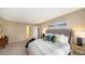 Spacious main bedroom with a comfortable upholstered bed and stylish decor with an entrance to the bathroom at 11 Sunset Dr # 303, Sarasota, FL 34236
