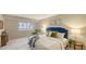 Inviting bedroom featuring a plush bed, bedside tables, and a relaxing ambiance, with bright windows at 11 Sunset Dr # 303, Sarasota, FL 34236