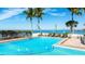 Beautiful community pool with ocean views and comfortable lounge seating at 11 Sunset Dr # 303, Sarasota, FL 34236