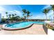 Community swimming pool with lounge chairs and palm trees at 11 Sunset Dr # 303, Sarasota, FL 34236