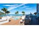 Gorgeous pool deck with comfortable lounge seating, tables, and palm tree views at 11 Sunset Dr # 303, Sarasota, FL 34236