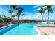 Beautiful pool area with palm trees and views of the ocean and plenty of seating for relaxing at 11 Sunset Dr # 303, Sarasota, FL 34236
