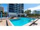 Resort pool with community building, lounge seating and easy access to community at 11 Sunset Dr # 303, Sarasota, FL 34236