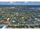 Overhead view of home and neighborhood with mature trees and city skyline in distance at 1231 S Orange Ave, Sarasota, FL 34239