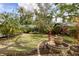 Lush backyard with manicured lawn, mature trees, and beautiful garden details at 1231 S Orange Ave, Sarasota, FL 34239