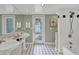 Stylish bathroom featuring dual sinks, tiled floors, and modern fixtures at 1231 S Orange Ave, Sarasota, FL 34239