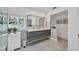 Modern bathroom with a double sink vanity, large mirror, and a walk-in shower with white tile walls at 1231 S Orange Ave, Sarasota, FL 34239