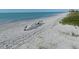 Relaxing beach scene with lounge chairs and gentle waves lapping at the shore on a sunny day at 1231 S Orange Ave, Sarasota, FL 34239