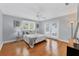 Bright bedroom with hardwood floors, ceiling fan, and access to the outdoors through French doors at 1231 S Orange Ave, Sarasota, FL 34239