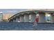 View under a large bridge with a windsurfer sailing in the water below on a beautiful day at 1231 S Orange Ave, Sarasota, FL 34239