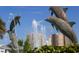 Lovely dolphin statue with a water fountain spraying, set against a backdrop of high-rise buildings at 1231 S Orange Ave, Sarasota, FL 34239