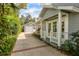 Charming exterior elevation featuring a well-manicured yard and a detached garage at 1231 S Orange Ave, Sarasota, FL 34239