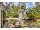 Detached garage with lush landscaping, stone walkway and adjacent screened porch at 1231 S Orange Ave, Sarasota, FL 34239