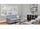 Cozy living room featuring a comfortable grey sofa and lots of natural light at 1231 S Orange Ave, Sarasota, FL 34239