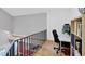 Bright office area with hardwood floors, black metal railing, and modern shelving unit at 1231 S Orange Ave, Sarasota, FL 34239
