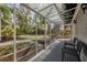 Relaxing screened porch with outdoor seating overlooking a lush backyard garden at 1231 S Orange Ave, Sarasota, FL 34239