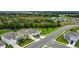 Aerial view of a two-story house with well-maintained lawn and nearby pond and trees at 12534 Nantahala Run Run, Parrish, FL 34219