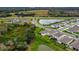 Aerial view of home featuring fenced backyard, screened-in porch, and serene pond view with neighborhood amenities at 12534 Nantahala Run Run, Parrish, FL 34219