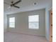 Well-lit bedroom features two sunny windows with white blinds and a ceiling fan at 12534 Nantahala Run Run, Parrish, FL 34219