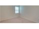 Neutral carpeted bedroom is well-lit with a window and has neutral walls at 12534 Nantahala Run Run, Parrish, FL 34219