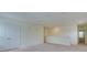 A well-lit and spacious carpeted living room with white walls and a double door closet at 12534 Nantahala Run Run, Parrish, FL 34219