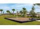 Community playground featuring swings, a soft landing surface, and a small grassy hill for recreation at 12534 Nantahala Run Run, Parrish, FL 34219