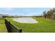 Scenic view of a serene pond surrounded by lush greenery, providing a tranquil backdrop at 12534 Nantahala Run Run, Parrish, FL 34219