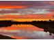 Beautiful sunset reflecting on a pond, painting the sky with vivid orange and purple hues at 12534 Nantahala Run Run, Parrish, FL 34219