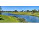 Picturesque golf course view with a winding river, manicured greens, and golfers enjoying the game at 12707 Deacons Pl, Lakewood Ranch, FL 34202