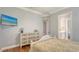 Main bedroom with TV, dresser, ensuite bathroom, and gleaming hardwood floors at 12707 Deacons Pl, Lakewood Ranch, FL 34202