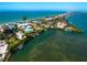 Aerial view of waterfront homes on a peninsula featuring lush landscaping, private docks, and stunning ocean views at 1304 Casey Key Rd, Nokomis, FL 34275