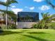 Lush backyard with a screened enclosure, offering a private outdoor retreat at 1304 Casey Key Rd, Nokomis, FL 34275