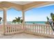 Beautiful balcony with stone columns overlooking a pristine beach and turquoise ocean at 1304 Casey Key Rd, Nokomis, FL 34275