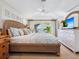 Inviting bedroom with balcony access, wicker furniture, and coastal decor at 1304 Casey Key Rd, Nokomis, FL 34275