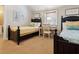 Charming bedroom with twin beds, a writing desk, and beach-themed decor at 1304 Casey Key Rd, Nokomis, FL 34275